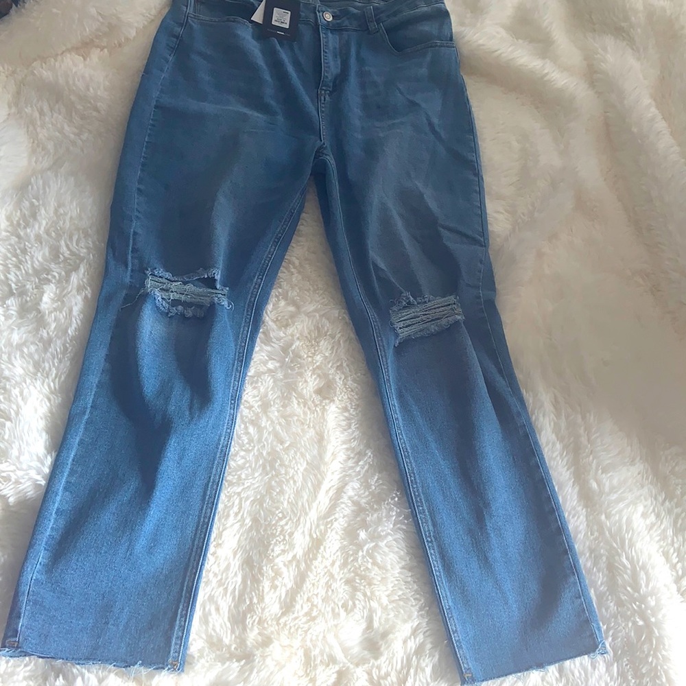 Distressed blue jeans with back leg slit